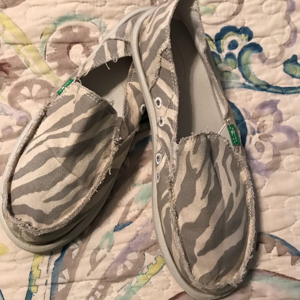 Zebra print slide on shoes.